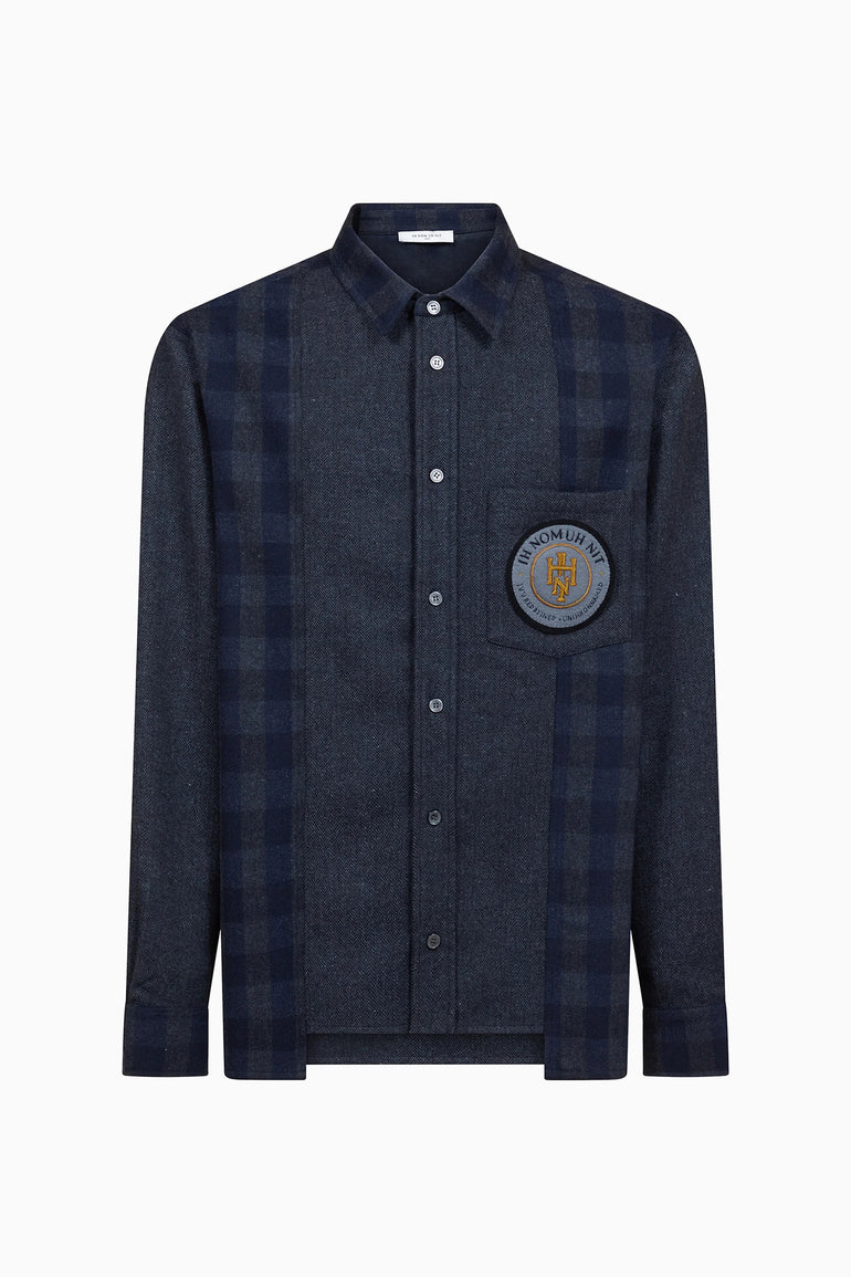 IH NOM UH NIT FW26 dark navy flannel shirt with check panels and embroidered chest patch, front view